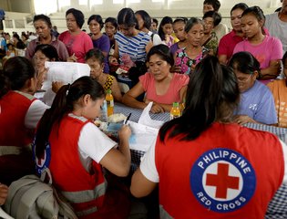 Red Cross volunteers register residents affected by flood caused by Typhoon Koppu, Philippines