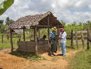 Kayin state. An ICRC staff member assesses the conditions of a well to prevent water shortages, which are common during the dry season.