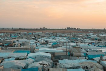 Overhead view of a refugee camp at sunset