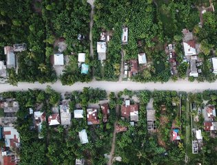 Aerial view of lush rural area in Port-au-Prince, Haiti, showcasing greenery and houses