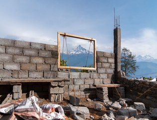 A construction site in Dhampus, Nepal, frames stunning view of Machhapuchhre peak.